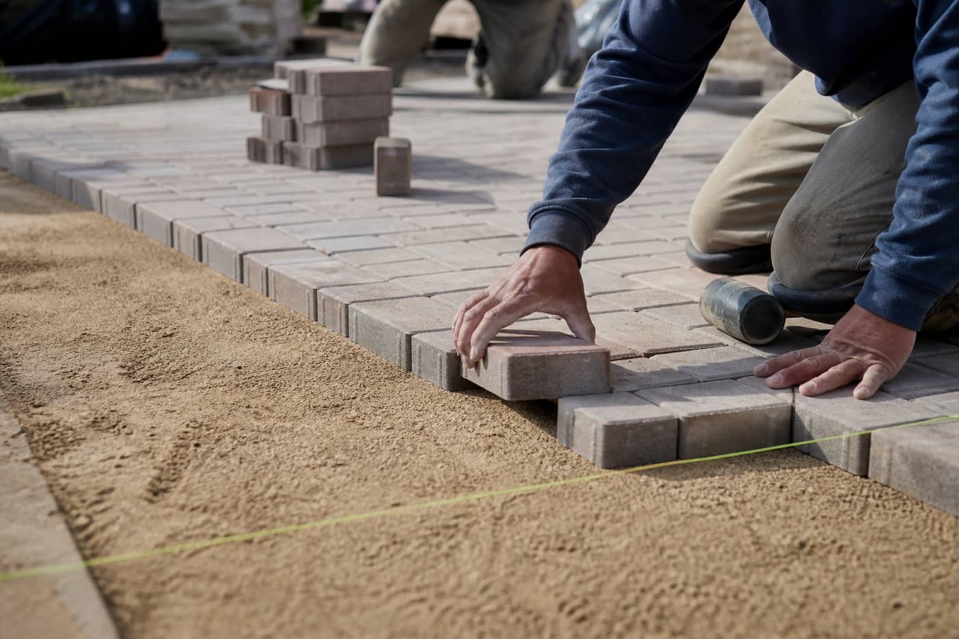 Hardscape crew installing paver patio in Charlotte Metro